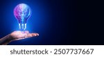 A hand holding a glowing lightbulb with a digital circuit inside, set against a dark blue background. Concept of technology and innovation