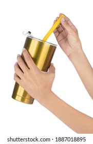 Hand Holding Gold Yeti Cup With Tube Isolated On White Background.