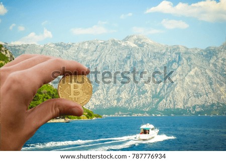 Hand holding golden bitcoin virtual money Shell with a golden bitcoin coin on the background of sea waves and the ocean find bitcoin