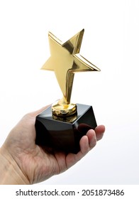 Hand Holding Golden Star Trophy On White Background.