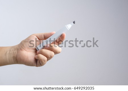 Hand holding gradient level adjustment permanent marker on white background