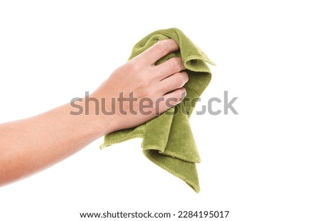 Hand holding green duster microfiber cloth used for cleaning isolated on white background