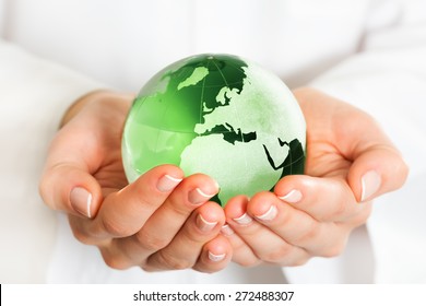 Hand Holding Green Glass Globe