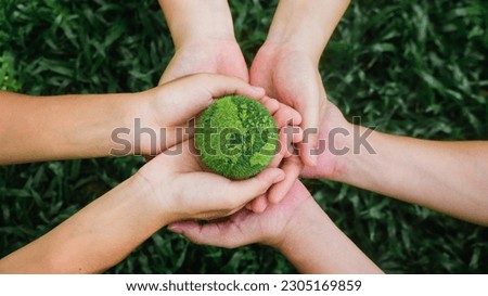 in hand holding green globe on green background Environmental concept, Earth Day and environmental protection. and environmental sustainability, helping the planet