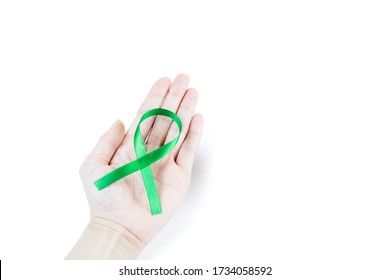 Hand Holding Green Organ Transplant Awareness Ribbon.Kidneys Cancer .healthcare And Medicine Concept 