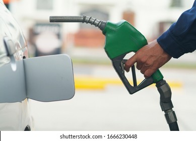 Hand Holding A Green Pistol For Automatic Petrol Pump