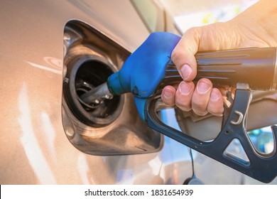 The hand holding the gun gas station refueling the car - Shutterstock ID 1831654939