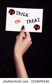 Hand Holding Halloween Card On Black Background 