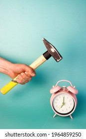 A Hand Holding A Hammer Smashing An Alarm Clock. Vertical Stock Photo For A Social Media Post. Killing Time, Time Management And Waking Up Early In The Morning Concept
