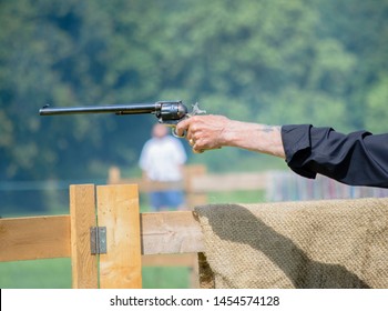 A Hand Holding A Handgun At A Sport Venue At The Local Village Fete UK