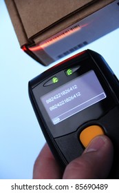 Hand Is Holding A Handheld Barcode Scanner