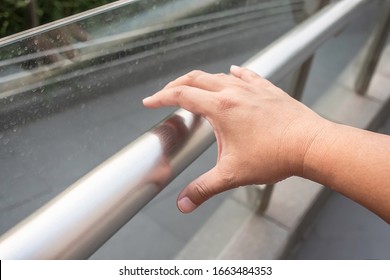 Hand holding a handle bar, The germ spread from person to person through direct physical contact