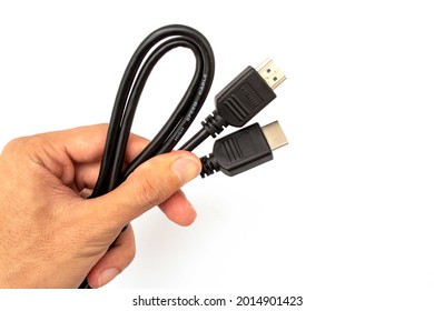 hand holding hdmi cable on white background
