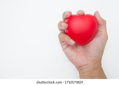 The Hand Is Holding Heart Shaped Squeeze Ball For Hand Muscle Exercise On White Background And Copy Space