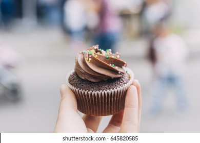 Hand Holding Homemade Cupcake