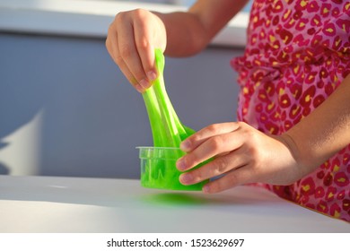 Hand Holding Homemade Toy Called Slime, Girl Having Fun And Being Creative By Science Experiment.