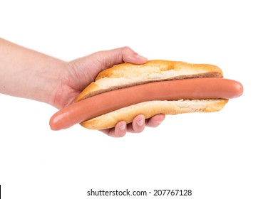 Hand Holding Hot Dog Bread And Sausage. Isolated On A White Background.