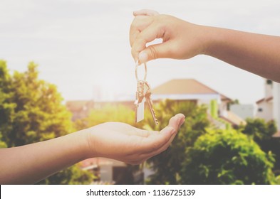 Hand Holding House Key On New Home Background,real Estate Agent,Mortgage Concept