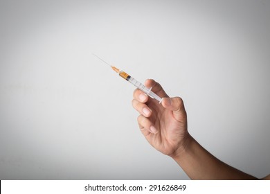 Hand Holding Hypodermic Needle