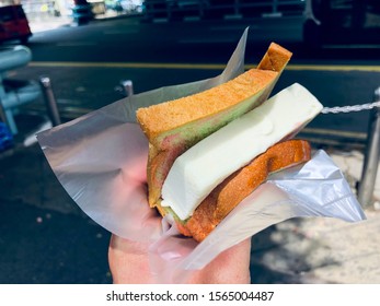 Hand Holding Ice Cream Bar Bread Sandwich. Street Food.