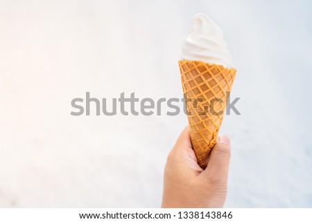 Hand holding ice cream with cone - sweet dessert food