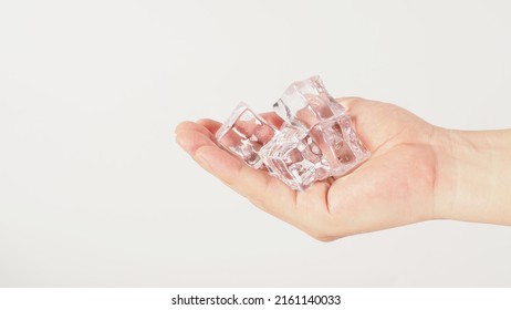 Hand is holding ice cube on white background.	 - Powered by Shutterstock