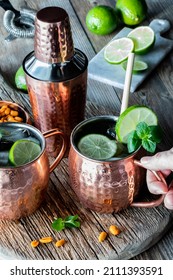 Hand Holding An Icy Cold Moscow Mule With Ginger Beer Cocktail. 