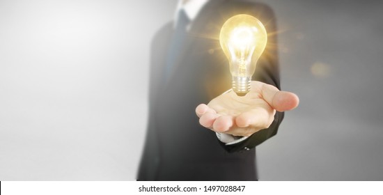 Hand of holding illuminated light bulb, idea, innovation inspiration concept - Shutterstock ID 1497028847