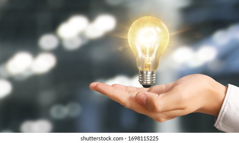 Hand of holding illuminated light bulb. idea  innovation inspiration concept