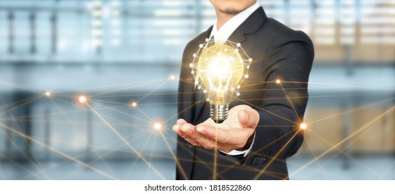 Hand of holding illuminated light bulb. idea innovation inspiration concept - Shutterstock ID 1818522860