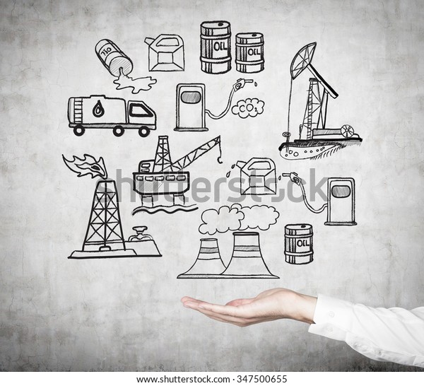 hand as if holding an illustration of oil\
industry components from extraction to petroleum stations on a\
concrete wall,  a concept of\
pollution,