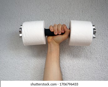Hand holding an improvised toilet paper roll dumbbells - trying to stay fit during coronavirus quarantine.