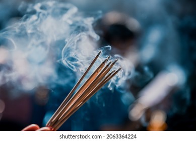 Hand holding incense sticks for worship, Close up shot