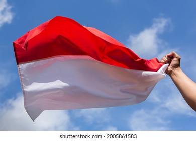 Hand Holding Indonesian Red And White Flag To Visualized Patriotism