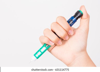 Hand Holding Insulin Pen On White Background