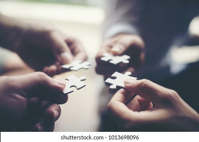 Hand holding jigsaw puzzles, Business partnership concept. - Shutterstock ID 1013698096