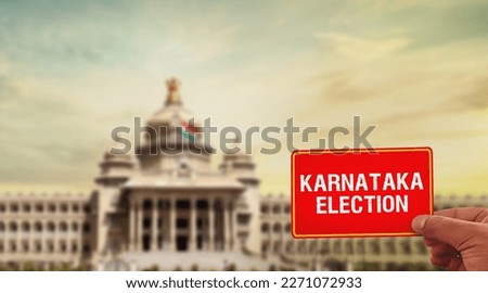 hand holding Karnataka election card  Vidhan Soudha in background karnataka election 2023 April