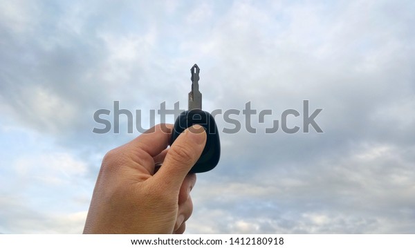 Hand\
holding key of car with flare lights background Concept for\
transport and cars insurance texture. -\
Image