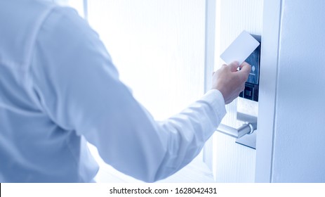 Hand Holding Key Card Using Electronic Card For Access Hotel Room.