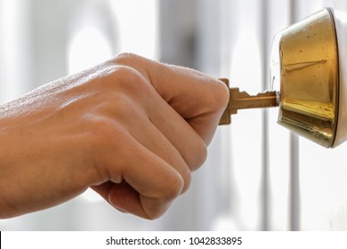 Hand Holding Key In Dead Bolt Lock