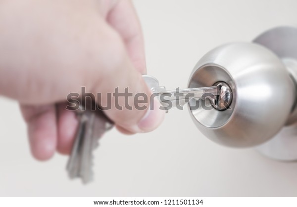 Hand Holding Key Unlock Door Knob Stock Photo Edit Now 1211501134
