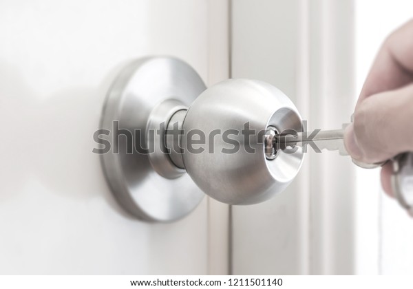 Hand Holding Key Unlock Door Knob Stock Photo Edit Now