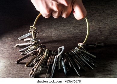A hand holding a lot of keys