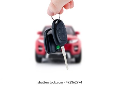 Hand holding keys to new red car. Buy or selling business composition