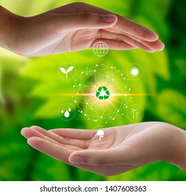 Hand holding light bulb against nature on green leaf with icons energy sources for renewable, sustainable development. Technology ,Environment ,Ecology concept. - Shutterstock ID 1407608363