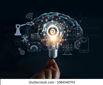 Hand holding light bulb and cog inside and innovation icon network connection on brain background, innovative technology in science and industrial concept 
