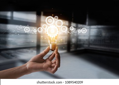 Hand holding light bulb and cog inside. Idea and imagination. Creative and inspiration. Innovation gears icon with network connection on metal texture background. Innovative technology in science   - Shutterstock ID 1089540209