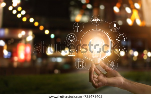Hand holding light bulb in front of global show the\
world\'s consumption with icons energy sources for renewable,\
sustainable development. Ecology concept. Elements of this image\
furnished by NASA. 