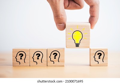 Hand holding lightbulb drawing which print screen on wooden cube block among human and question mark for creative thinking idea and problem solving concept. - Powered by Shutterstock