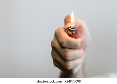 Hand Holding A Lighter.